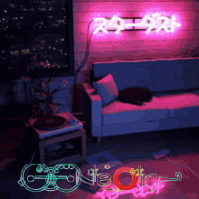a neon sign hangs above a couch and a record player