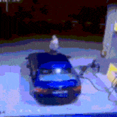 a blurry picture of a blue car with a license plate that says ' volkswagen '