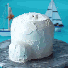 a cake that looks like an igloo is sitting on a marble plate