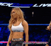 a woman is standing in a wrestling ring with the words women 's champion behind her