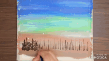 a person is painting a landscape with trees and the words made in animatica