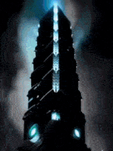 a very tall building with a blue light on the top of it