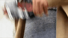 a close up of a person 's hand holding a bottle of water