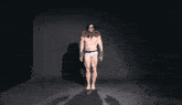 a man is standing in front of a screen that says toxic