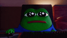 a green frog with big eyes is sitting at a computer keyboard