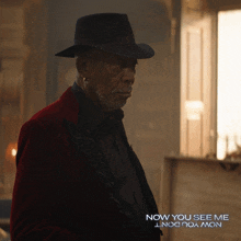 an advertisement for now you see me shows a man wearing a black hat