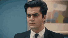 a close up of a man in a suit and tie making a funny face .