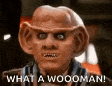 a close up of a man with a mask on his face and the words `` what a wooman ! ''