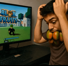 a man playing a game called blox fruits on a computer