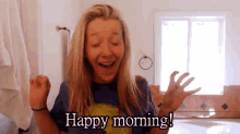 a woman in a bathroom with her arms in the air and the words happy morning .