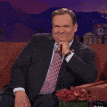 a man in a suit and tie is clapping