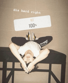 a person laying on their stomach with a sign that says " dis hard right "