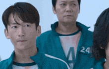 a man in a blue jacket with the number 24 on his chest