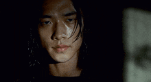 a close up of a man 's face with a black background
