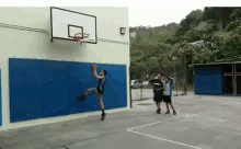 a man playing basketball on a court with the word apex on the hoop