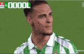 a soccer player in a green and white jersey with the number 7 on the front