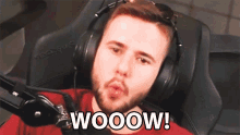 a man wearing headphones with the word wooow written on his face