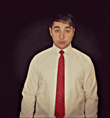 a man in a white shirt with a red tie