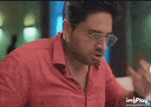 a man in a red shirt is shown in a gif that says imgplay on the bottom