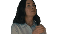 a woman is blowing a kiss with her hand