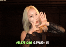 a woman with blonde hair and a tattoo on her arm is smiling and waving her hands