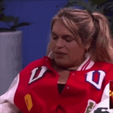 a woman in a red jacket with the letter u on it