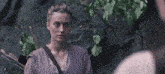 a woman in a purple dress with a bow and arrow