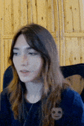 a woman wearing headphones and a smiley face on her shirt
