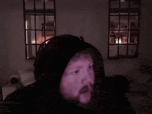 a man in a dark room with the words we are absolutely cooked chat behind him