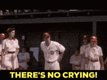 a group of baseball players standing in a dugout with the words " there 's no crying "