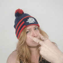 a woman wearing a blue and red beanie that says " nous sommes l' olympique britannie "