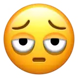 a yellow smiley face with a sad look on its face and closed eyes .