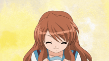 a girl with long brown hair is smiling and looking down