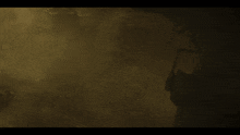 a person is riding a motorcycle in the dark with a green light shining on them .