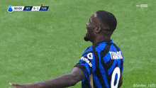a soccer player wearing a blue and black jersey with the number 2 on it