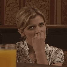a woman with a ring on her finger sitting at a table