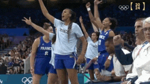 a group of female basketball players from france are celebrating their victory