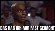 a bald man says das hab ich mir fast gedacht in front of a crowd of people