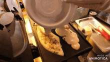 a person is pouring something on a griddle that says made in animotica