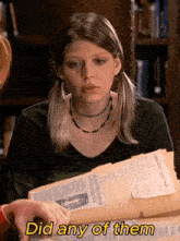 a woman holding a newspaper with the words " did any of them " written on it