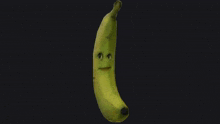 a close up of a banana with a funny face on it .