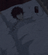a man is sleeping on a bed with a cell phone plugged into it