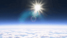 the sun is shining brightly over the clouds in the sky