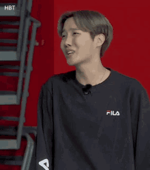 a close up of a person wearing a fila sweatshirt