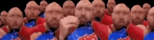a group of men wearing red and blue shirts are standing in a line .