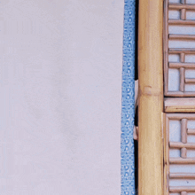 a woman peeking out from behind a curtain with the letter t on it