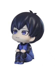 a figurine of a boy with blue eyes and a blue shirt that says me