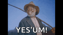 a man in a cowboy hat is smiling and holding a stick with the words yes um written below him