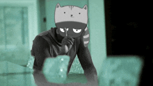 a man with a cat face on his head sitting at a table