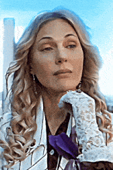 a woman is wearing a white lace glove and a purple bow